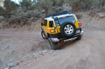 FJ back wheel in a hole, but suspension flex is good! Torques out of it!