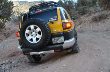FJ back wheel in a hole, but suspension flex is good! Torques out of it!