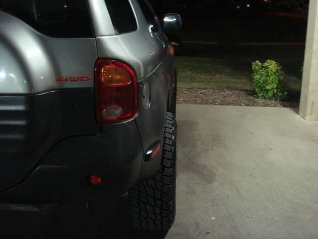 how much new tires and rims stick out back.