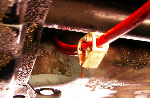 Trans fluid fill hose with clip